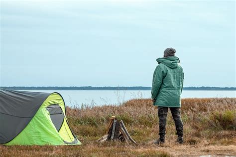 Premium Photo | A bearded man near a camping tent in green nature and ...