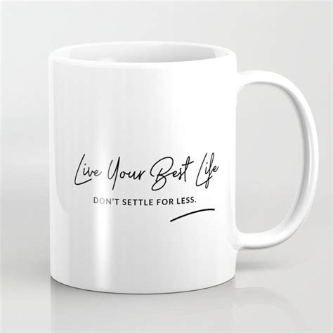 a white coffee mug that says live your best life don't set it for less