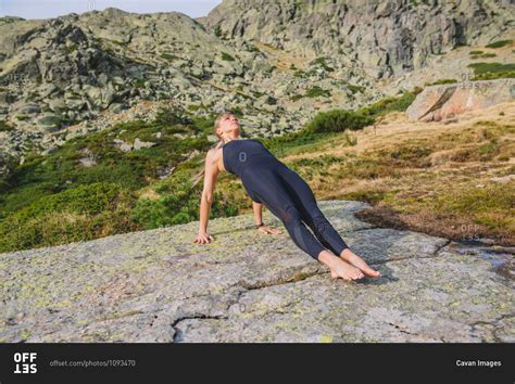 Yoga poses woman mountain healthy stock photo - OFFSET