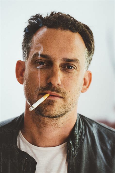 Headshot Of Cool Caucasian Man Smoking A Cigarette | Stocksy United