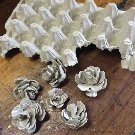 several pieces of art made out of egg shells sitting on a table next to ...