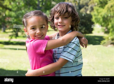 Little siblings hugging each other Stock Photo - Alamy