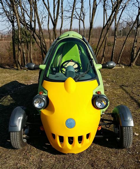 sam is a bug-eyed three-wheeled two-person electric vehicle