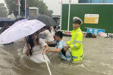 Flood toll rises in central China, as tens of thousands evacuated ...