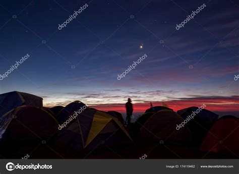 Camping man standing in camping area against beautiful colorful Stock ...