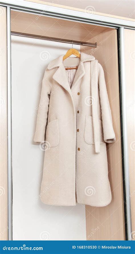 White Female Coat on Hangers in the Closet Stock Photo - Image of ...