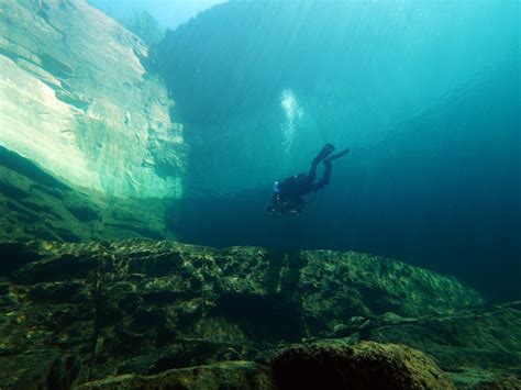 Premium Photo | People diving in quarry lake