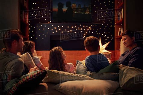 Family Enjoying Movie Night At Home Together - Stock Photo - Dissolve