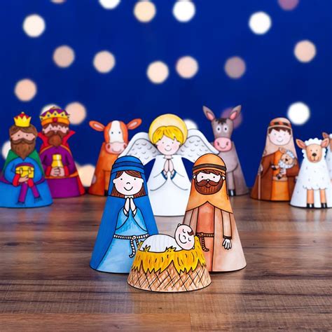 paper cut out of the nativity scene on a wooden floor with lights in ...