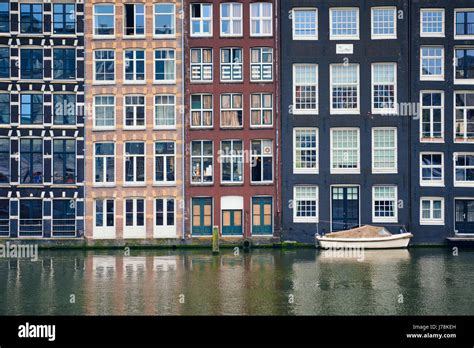 Amsterdam canal Damrak with houses, Netherlands Stock Photo - Alamy