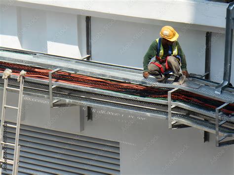 Electrical contractor installing electrical cable tray at the ...