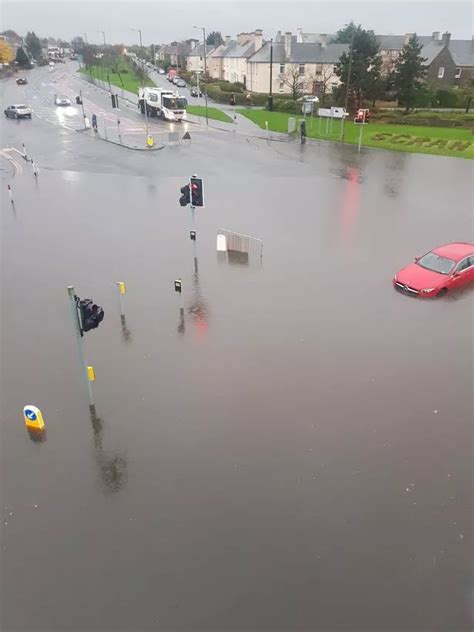 Busy Edinburgh road flooded as heavy rain causes travel chaos ...