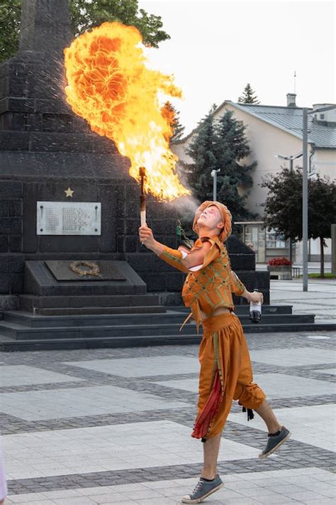 Photo of Person Fire Breathing on Pavement · Free Stock Photo