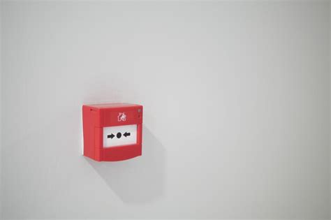 Premium Photo | Red fire alarm button on wall