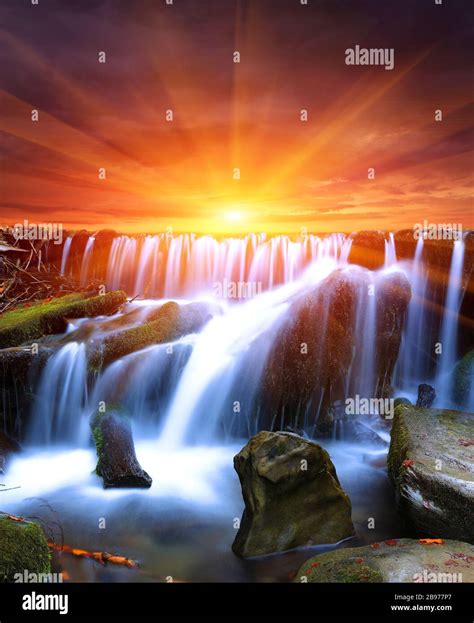 Nice sunset scene with waterfall Stock Photo - Alamy