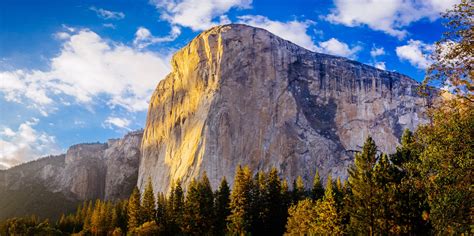 sunlight illuminates the face of the el capitan rock formation in ...