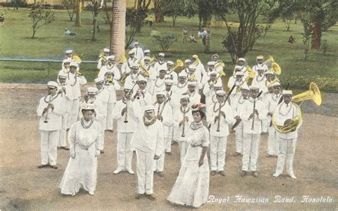 a group of men standing next to each other in front of a lush green field