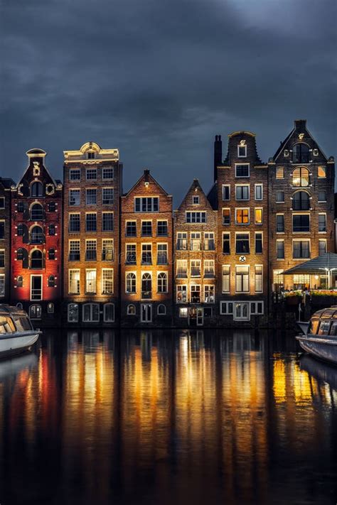 Night Dancing Houses at Amsterdam Canal Damrak, Netherlands Stock Image ...