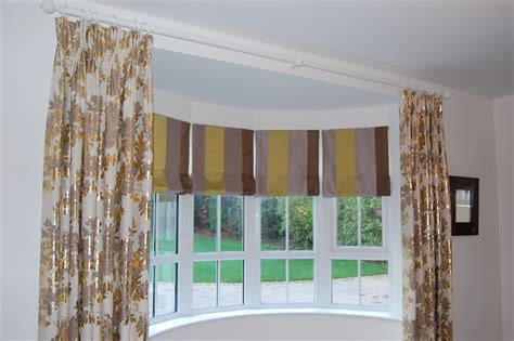 Diana Murray Interiors Roman blinds in bow window with dress curtains ...