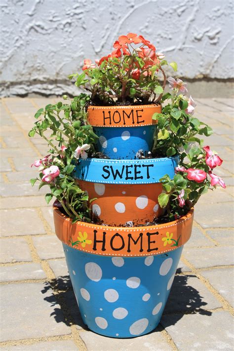 Tiered terracotta pots | Painted flower pots, Terra cotta pot crafts ...