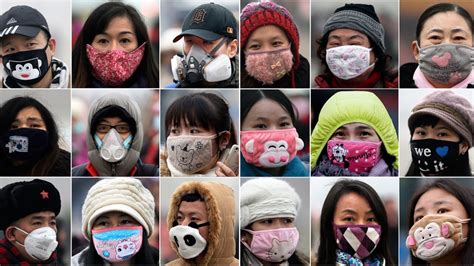 Beijing locals don colourful face masks as smog hovers over city | CTV News