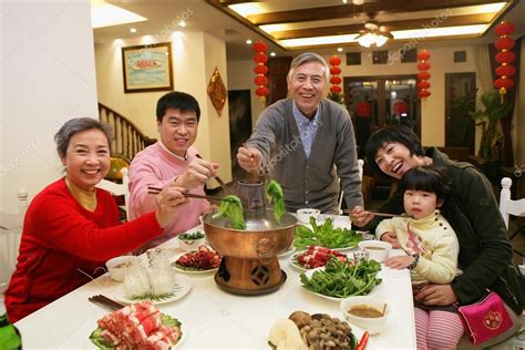 A shot of Chinese family at dinner table — Stock Photo © ViewStock ...