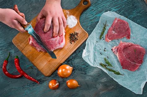 Free Photo | Butcher cutting pork meat on kitchen