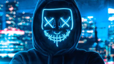 Download Guy In Neon Blue Light Purge Mask Wallpaper | Wallpapers.com