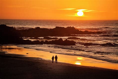 Couple Watch The Sunset At Carmel Beach by Pgiam