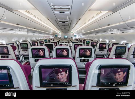 Interior view of the economy class section of the Qatar Airways Airbus ...