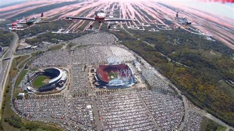 an aerial view of several airplanes flying over a stadium