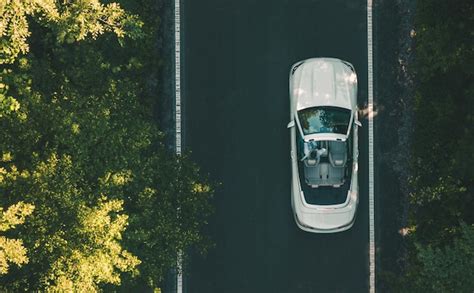 Premium Photo | Aerial view of white convertible car on a road