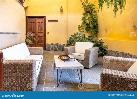 House Interior with a Straw Sofa, White Small Table, Espaliered Plant ...