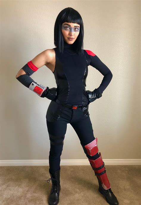 a woman dressed in black and red poses for the camera with her hands on ...