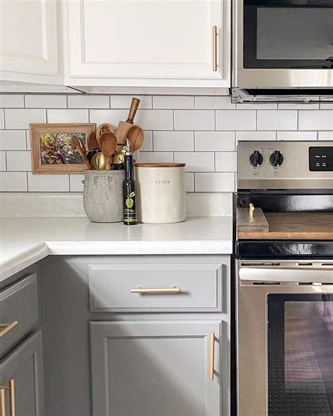 Stainless Steel Stove Pushed Against White Subway Tile Backsplash ...