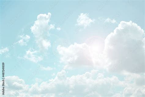 Sky. White clouds and sun rays in a light blue sky. The sky is in very ...