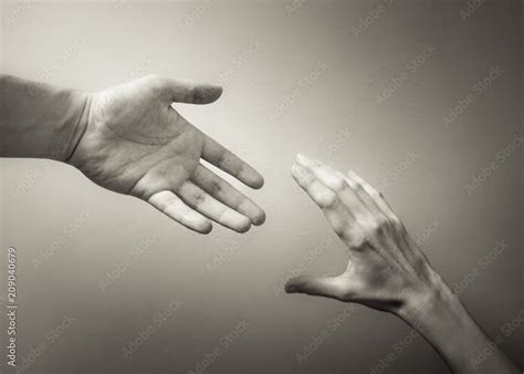 Giving a helping hand. Hand reaching out to help another. Stock Photo ...