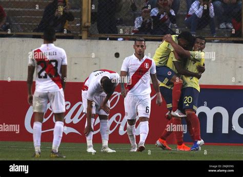 Colombia's players, right, celebrate their third goal against Peru ...