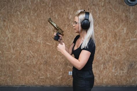 Premium Photo | A girl at a shooting range with a desert eagle pistol ...