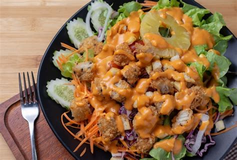 Premium Photo | Salad and cheese dressing on table