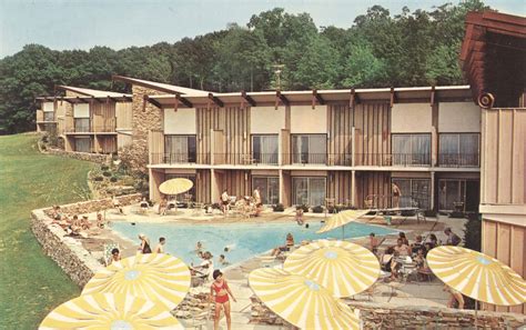 an old photo of people in the pool at a motel or resort with yellow ...