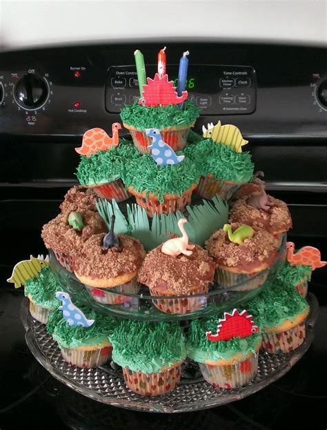 Dinosaur cupcakes. I made my own cupcake stand with a platter, cake ...