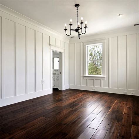 Vertical Board and Batten Walls Frame a Coastal White Bedroom Sitting ...