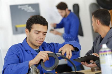 Car Mechanic Man at Garage Fixing Engine Stock Photo - Image of ...