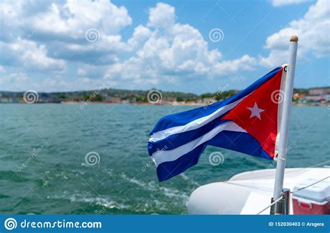 Cuba Flag Waving on Boat at Sea Near Cuban Coastline Stock Image ...