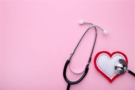 Premium Photo | Stethoscope and heart on pink