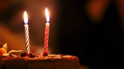 Two Candles On Birthday Cake Burning In The Darkness. Stock Footage ...