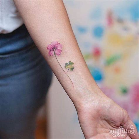 Clover flower tattoo on the inner forearm.