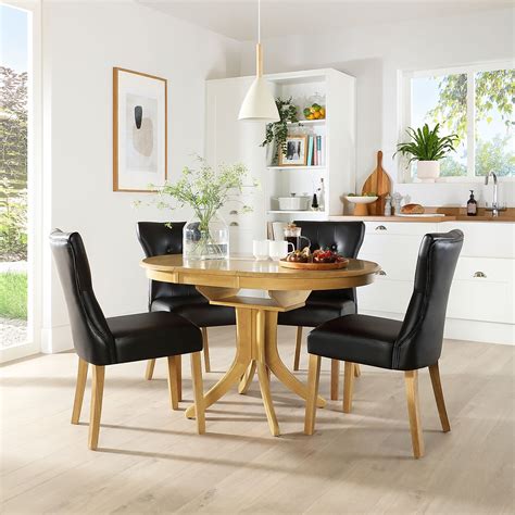 Hudson Round Oak Extending Dining Table with 6 Bewley Black Leather ...