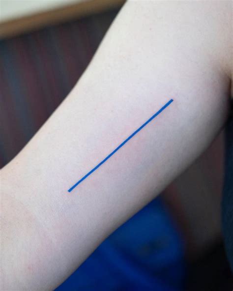 Blue line tattoo located on the inner arm, minimalistic